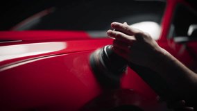 Close Up of a Person Working in a Detailing Studio, Spreading Polishing Paste on a Red Sportscar to Return it to Factory Condition. Technician Buffing the Fender with a Polishing Machine - Powered by Shutterstock - Get 15% off with code: PIKWIZARD15