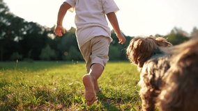 bare feet. baby boy is playing in the forest park. close-up child legs run on the park green grass in the park. family childhood dream concept. a child in sneakers run on the grass in fun a park - Powered by Shutterstock - Get 15% off with code: PIKWIZARD15