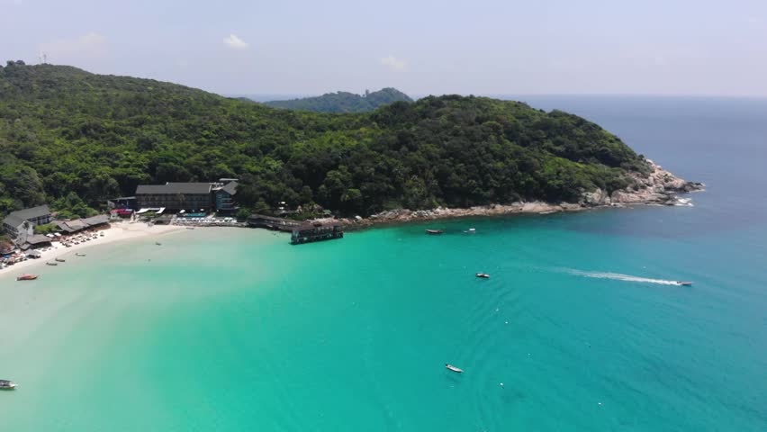 Beautiful aerial view of refreshing beach near green tropical mountains