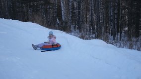Video of a happy girl in a bright orange jumpsuit and a blue hat riding on a stick, dad leads the girl through the winter forest. Winter fun for children. - Powered by Shutterstock - Get 15% off with code: PIKWIZARD15