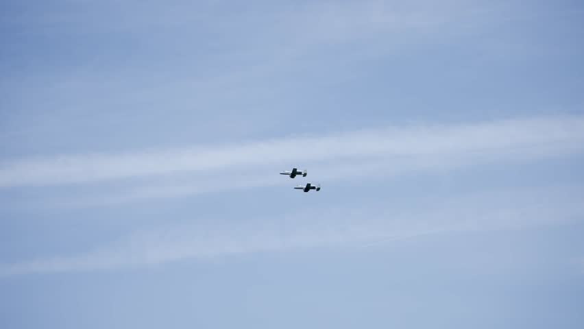 Slow motion view of a military planes fly in formation