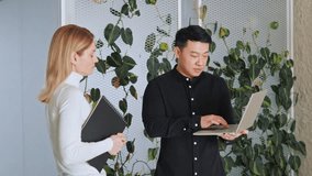 Startup investment diverse business meeting between asian investor and caucasian female startupper businesswoman. Business poeople discussing new project, financial market data using laptop.  - Powered by Shutterstock - Get 15% off with code: PIKWIZARD15