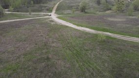Vehicle driving across the field drone view epic video. High quality 4k footage
