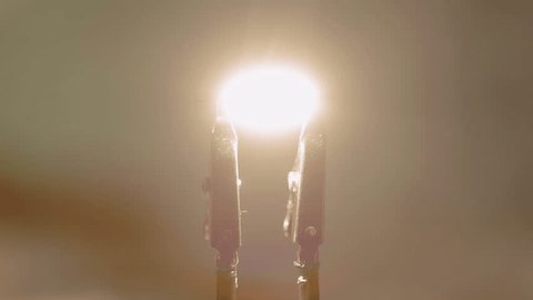 slow motion of the moment a carbon filament light is ignited. This is without the glass bulb so the flame is more pronounced.: film stockowy