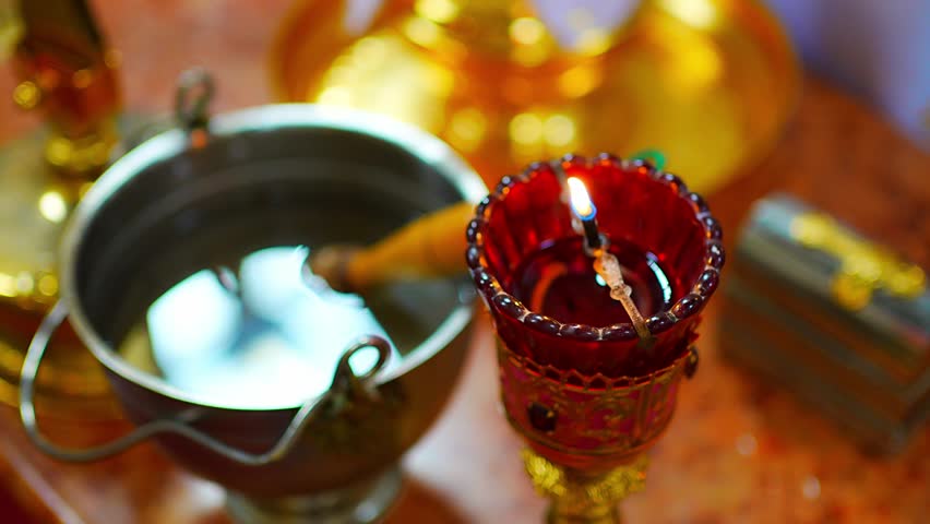 Candle burns during a christening ceremony in church Cathedral of St. Clement in Prague, Czech republic. High quality 4k footage