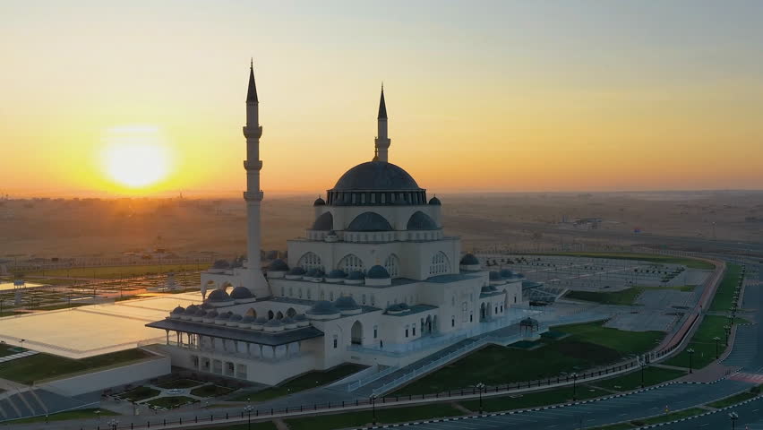 Aerial view of the Sharjah Mosque. The largest mosque in Sharjah. The letters in Arabic mean: indeed, prayer was imposed on believers by decree of a certain time. Quran surah An Nisa. | Shutterstock HD Video #1100406337