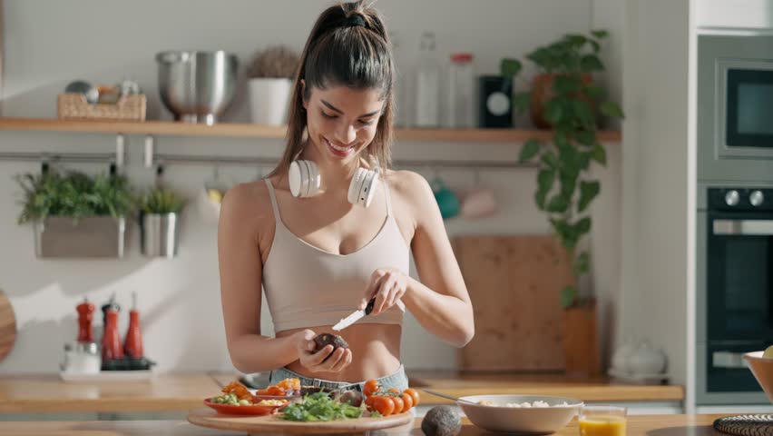 Video of fitness woman making a healthy poke bowl in the kitchen at home.