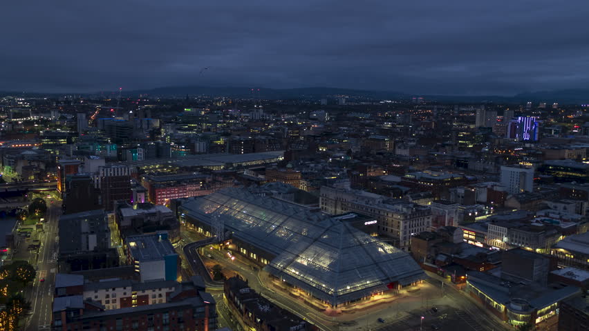 Establishing Aerial View Shot of Glasgow UK, Lanarkshire, Renfrewshire, Scotland United Kingdom night evening, super clear sharp image, pull back, city center, bird chase camera