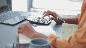 Asian Business woman using calculator and laptop for doing math finance on an office desk, tax, report, accounting, statistics, and analytical research concept - Powered by Shutterstock - Get 15% off with code: PIKWIZARD15