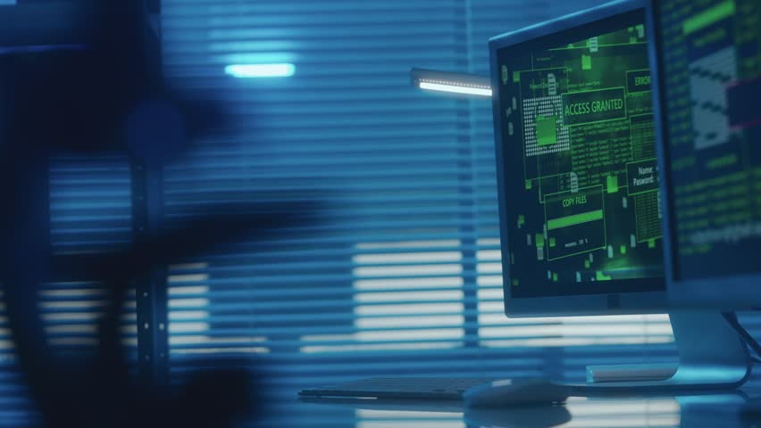 Computer screen with green line of program code and warning access denied and access granted. In the background, a man in a black hoodie shines a flashlight. Hacker penetration into office. - Powered by Shutterstock - Get 15% off with code: PIKWIZARD15