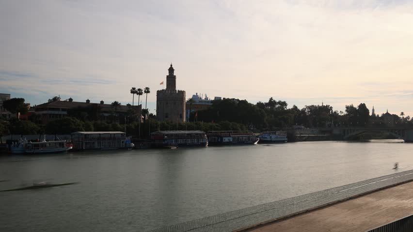 Time lapse of the Guadalquivir river and the Torre del Oro in Seville, Spain. 
