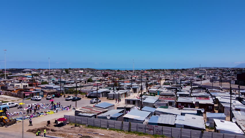 Aerial riser over township with market and corrugated iron shacks; Zwelihle