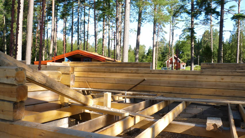 View of a log cabin under construction.