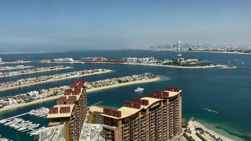 Dubai, a view from a height of the Jumeirah palm to yachts, villas, in the distance the sail hotel.