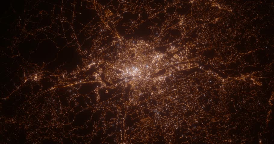 Manchester (New Hampshire, USA) top view at night. View on modern city from satellite. Camera is zooming in, rotating counterclockwise. Vertical video. The north is on the left side