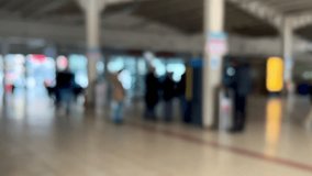 people, blurred background or surface with passengers or people walking in a station or shopping mall interior. men and women walking interior of building. blurred travel or public transportation 4k