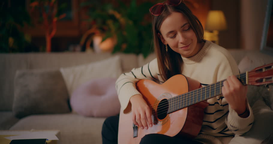 Woman Playing Acoustic Guitar at Home Composing Music Songwriting