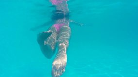 Young woman swims and dives in the beautiful swimming pool, Diving in the private swimming pool, Video clip