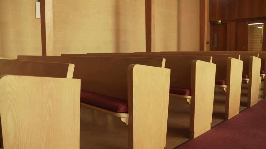 Wide dolly shot of empty pews in a historical church building. | Shutterstock HD Video #1100430141