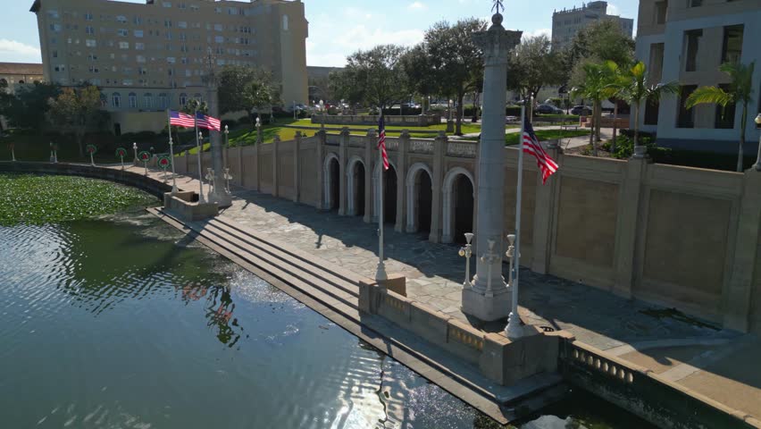 Aerial fly by of the Loggia on Lake in Lakeland, Florida. American flags wave in the mild wind. 