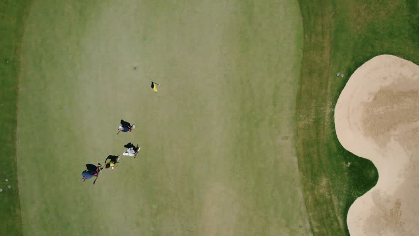 Aerial top down view of golfers in a El Paraíso Golf Course in Marbella, Spain. 