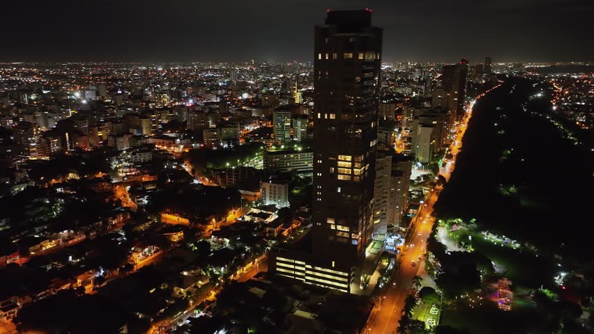 Anacaona Tower At Night. Apartment Building With Overview Of Santo Domingo City In The Dominican Republic. aerial orbit
