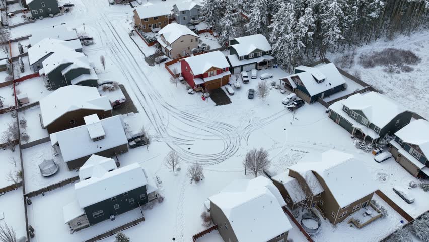 Drone shot of an American neighborhood covered by a sheet of snow.