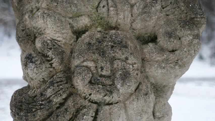 The face of an ancient, stone Slavic idol in Ukraine in winter