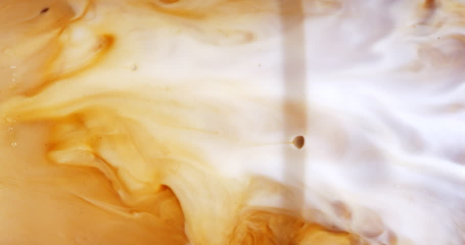 4K footage vertical video front view SLO MO CU, Cappuccino iced coffee mug where milk is being mixed with coffee, coffee art concept. | Shutterstock HD Video #1100438963