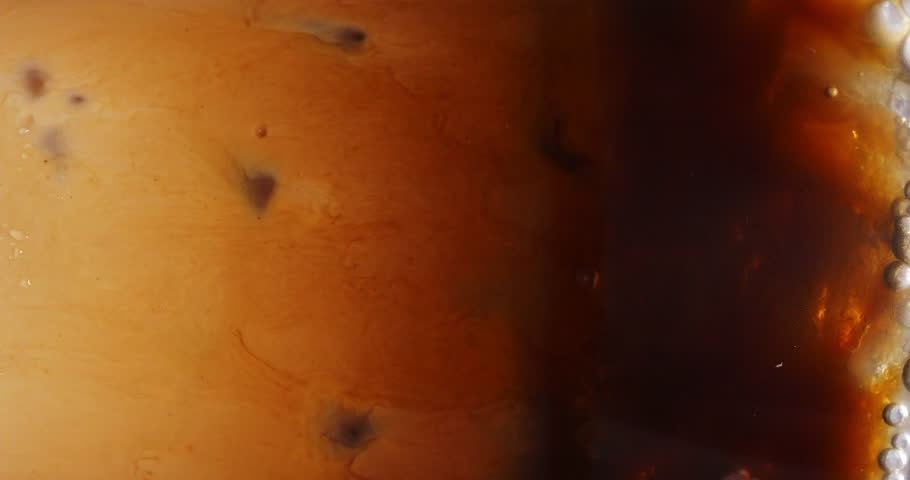 4K footage vertical video front view SLO MO CU, Cappuccino iced coffee mug where milk is being mixed with coffee, coffee art concept. | Shutterstock HD Video #1100438967
