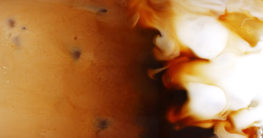4K footage vertical video front view SLO MO CU, Cappuccino iced coffee mug where milk is being mixed with coffee, coffee art concept. | Shutterstock HD Video #1100438967