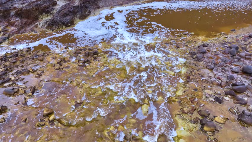 Rio Tinto textures. Aerial view from a drone in the surroundings of the town of Berrocal. Sierra Morena, Gulf of Cádiz, Huelva, Andalusia, Spain, Europe