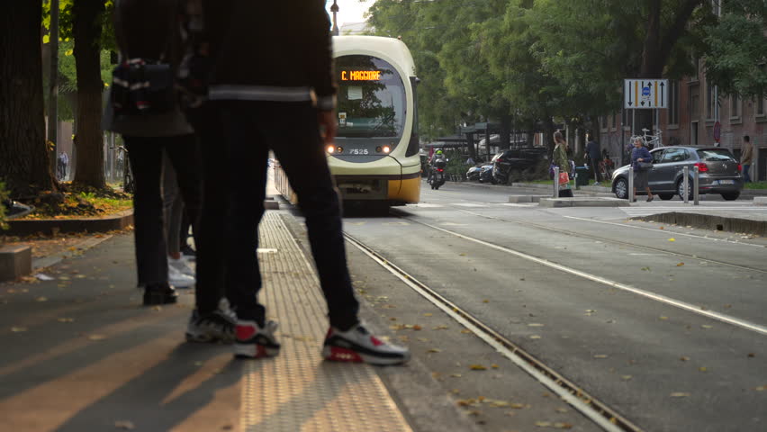 People taking a tram Milan City public transport sunset taken on 2023