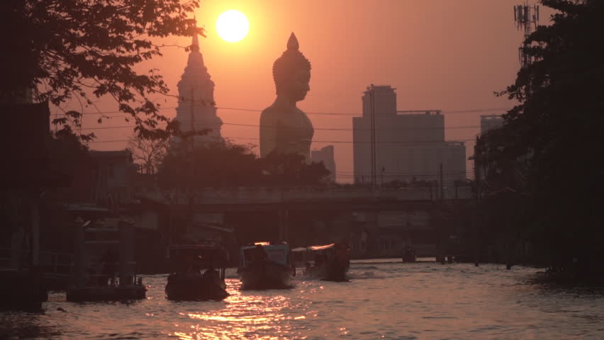 Evening sunset behind the Giant Buddha Statue at Wat Paknam Phasi Charoen in Bangkok, Thailand.