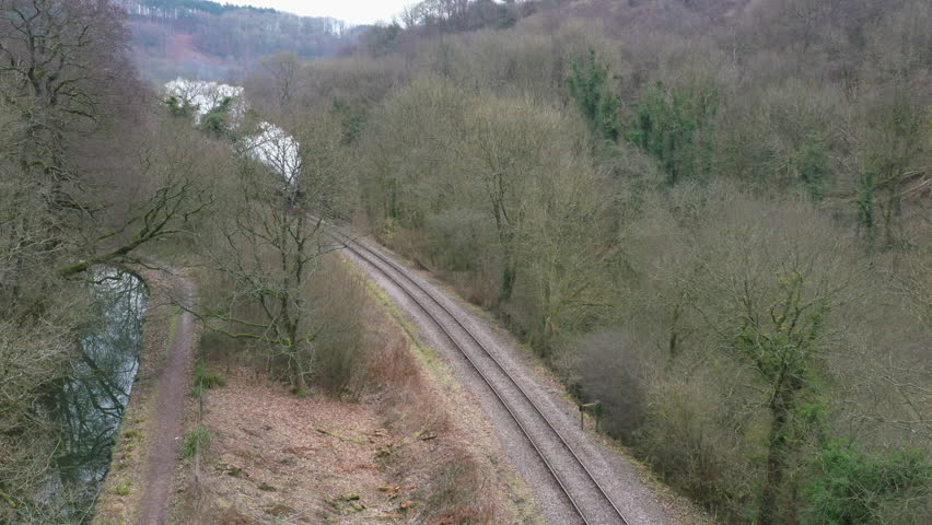 Steam train aerial view from drone moving through the English countryside in winter tourism UK 4K