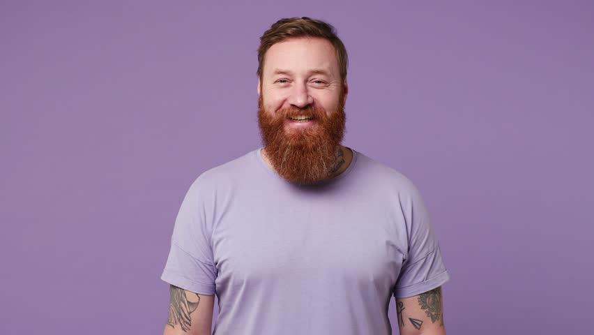 Young cheerful happy positive optimistic caucasian european man 30s wearing casual clothes looking camera smiling isolated on plain pastel light purple background studio portrait. Lifestyle concept