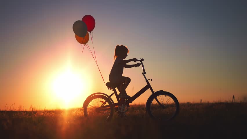 Girl kid silhouette bike riding on a park. kid girl rides a bike in nature in the park on the road. happy family kid dream concept. daughter plays a bike rides on a sandy lifestyle road | Shutterstock HD Video #1100449851