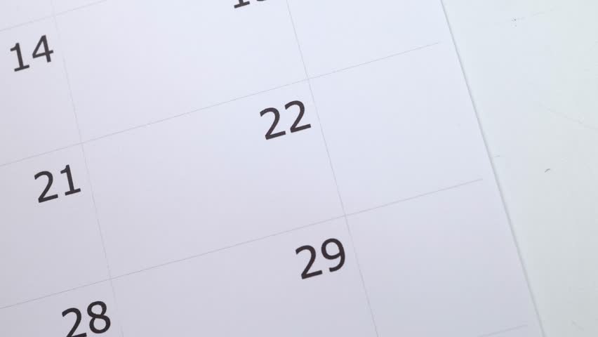 A calendar showing the number 22 with a males hand circling the date with a red pen, save the date or appointment reminder concept. Royalty-Free Stock Footage #1100451385