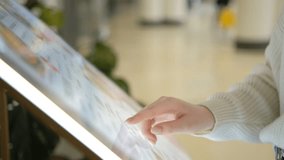 Woman looking for information and store location on digital touch screen in shopping mall 4K - Powered by Shutterstock - Get 15% off with code: PIKWIZARD15