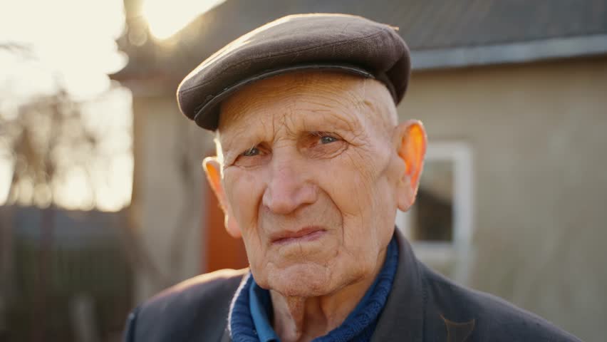 Portrait of an elderly grandfather smiling and looking at the camera | Shutterstock HD Video #1100453633