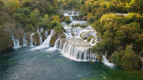 Krka, Croatia - 4K Flying over the beautiful Krka Waterfalls in Krka National Park on a bright summer morning with green foliage and turquoise water Stock-video