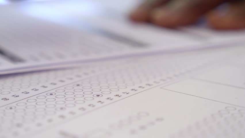 hand of young black man fills out a a multi choice test