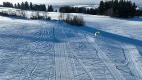 Drone video of a kitesurfer in winter in the snow. Snowkiting in the mountains