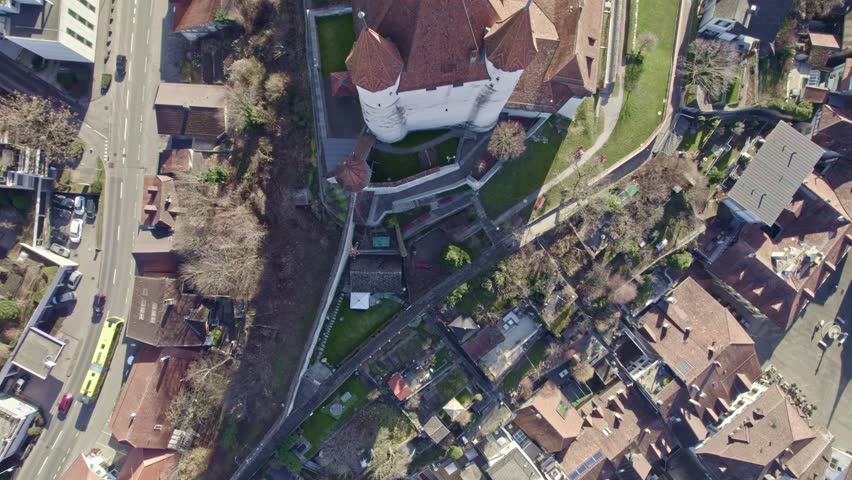 Top view of castle on a hill at City of Thun on a sunny winter day. Movie shot February 21st, 2023, Thun, Switzerland.