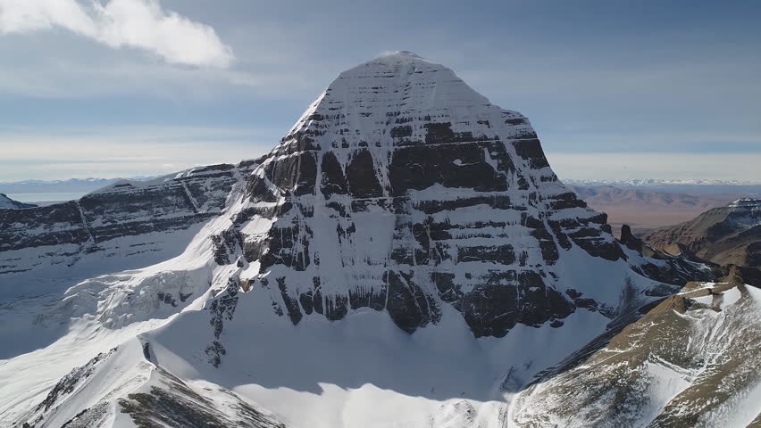 Aerial view of the southern side of Mount Kailash (height 6638 m), which is part of the Transhimalai in Tibet. It is considered a sacred site in four religions: Bon, Buddhism, Hinduism and Jainism. Royalty-Free Stock Footage #1100457767