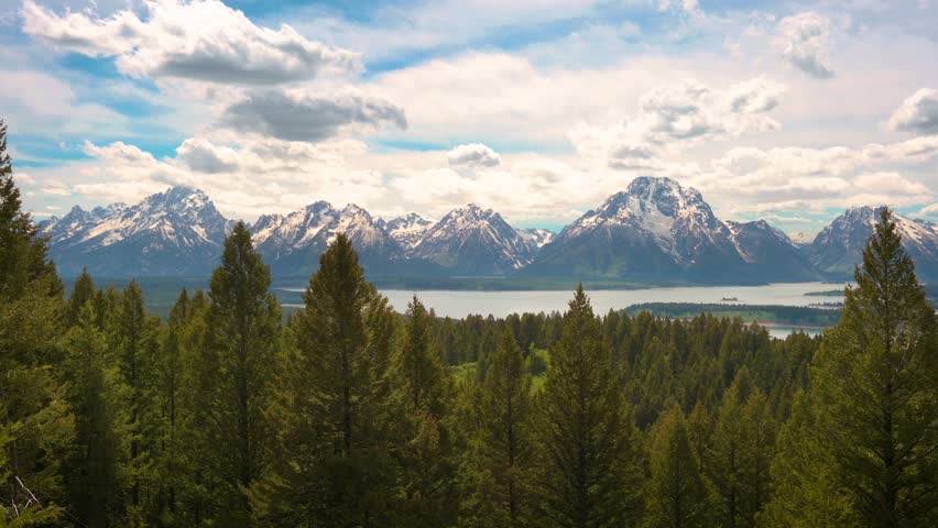 Pan right of Grand Teton Mountains and Jackson Lake from Jackson Point Overlook in Wyoming, USA. 4K UHD video.