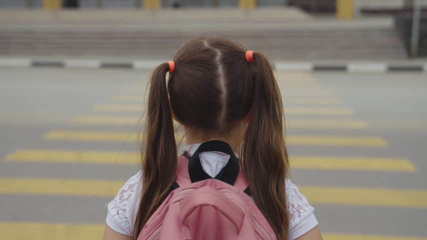 child with backpack crosses road pedestrian crossing. running child pedestrian crossing sign. zebra road near school. cars let child running school for lesson class. running child bag school concept. Royalty-Free Stock Footage #1100461879