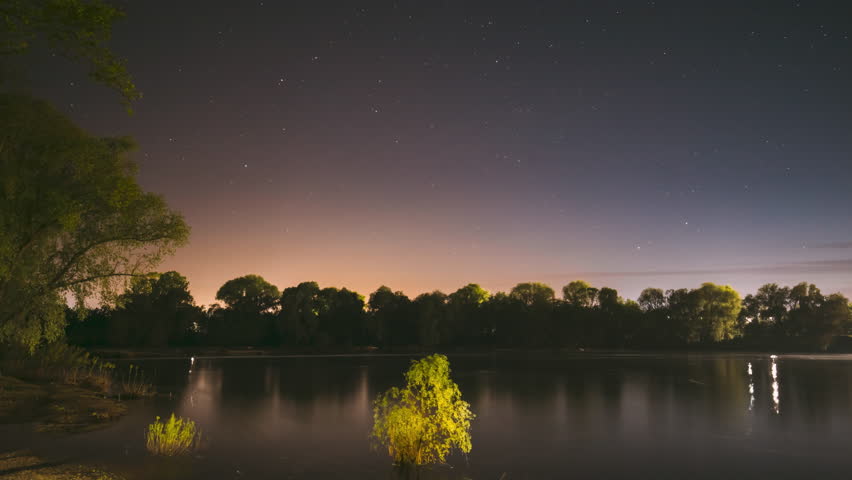 Night Sky Above River. 4k Timelapse. Stars Float Across Sky. Dawn Is Coming. Night Sky Turns Into Morning. From Dusk To Dawn. Time Lapse. Time-lapse. Timelapse.