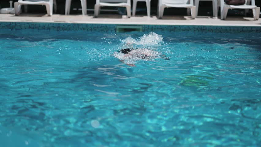Swimmer man doing crawl swim in swimming pool portrait. Closeup of athlete wearing goggles, slow motion Royalty-Free Stock Footage #1100465229