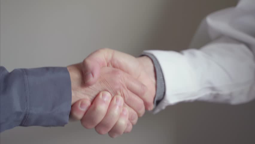 Doctor patient trust bond concept. Female patient and male doctor shake hands | Shutterstock HD Video #1100465605